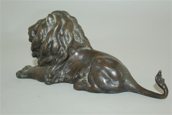 A patinated bronze model of a recumbent lion, 9in.